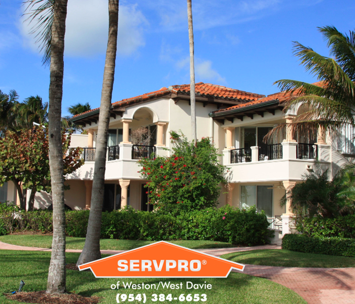 Exterior of home with SERVPRO logo.