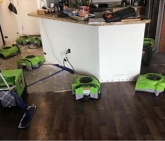 air movers placed around kitchen after water damage