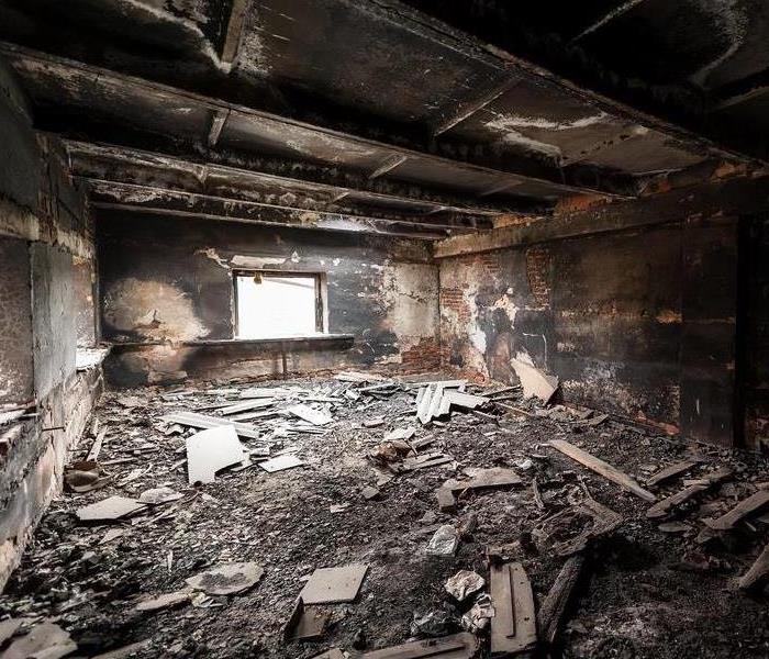 Inside of a home covered in soot and debris.